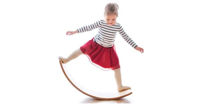 girl balancing on balance board