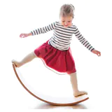 Little girl balancing on gentle monsters balance board