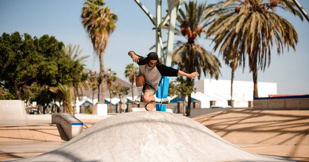 Guy doing difficult tricks on balance board in skate park