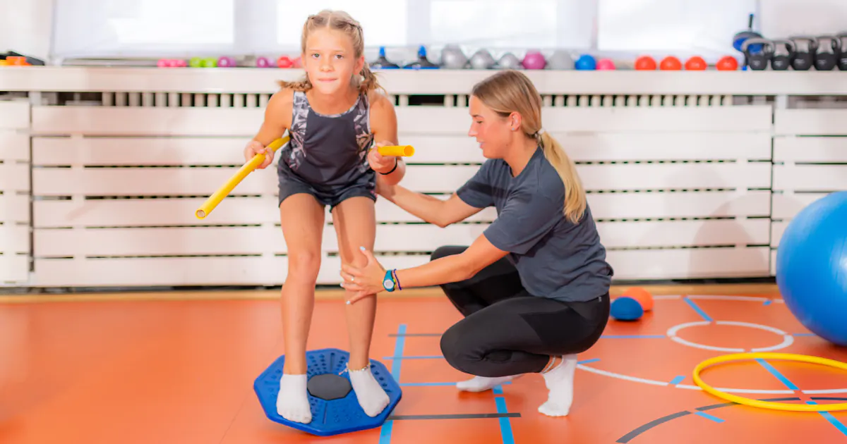 Girl uses balance board for sports training
